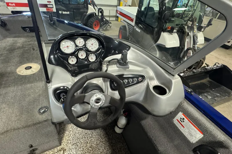 Slide: The Image of 2014 Tracker Pro Guide V-175 WT boat dashboard with steering wheel and gauges. - 10