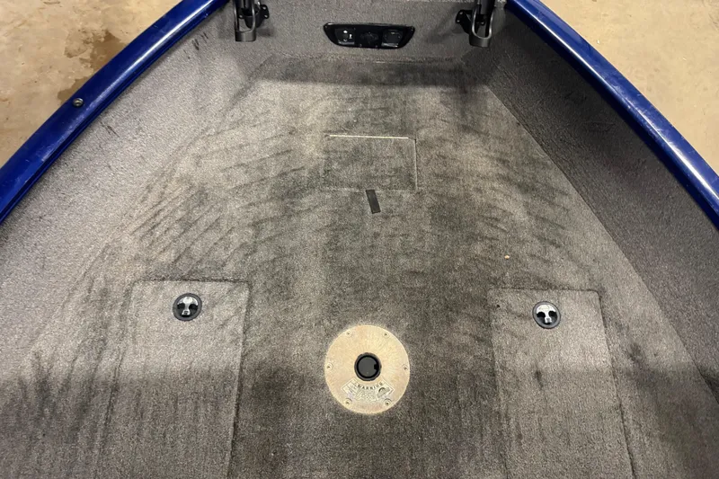 Slide: The Image of 2014 Tracker Pro Guide V-175 WT boat interior with carpeted deck and storage compartments. - 13