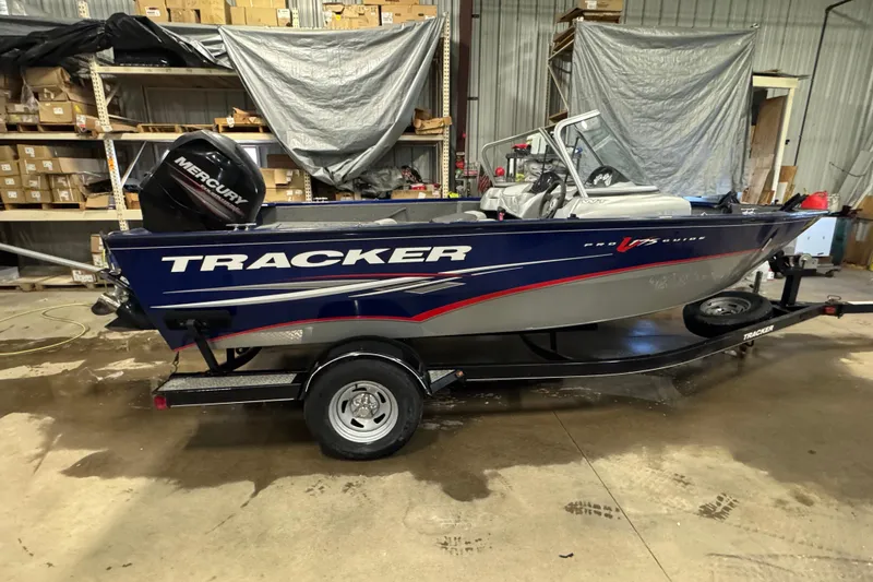 Slide: The Image of 2014 Tracker Pro Guide V-175 WT boat in a warehouse setting. - 4