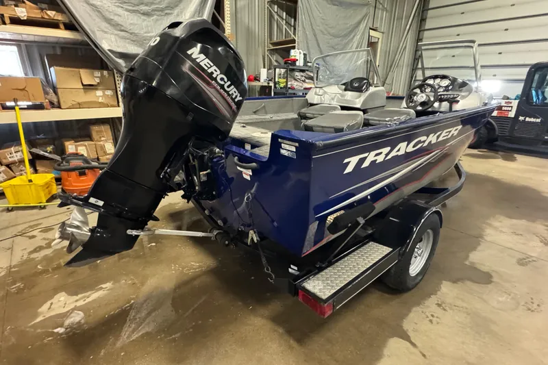 Slide: The Image of 2014 Tracker Pro Guide V-175 WT boat with Mercury outboard motor in a garage setting. - 5