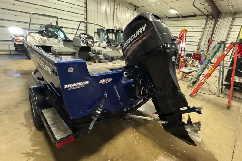 Slide: The Image of 2014 Tracker Pro Guide V-175 WT boat with Mercury outboard motor in a garage. - 6