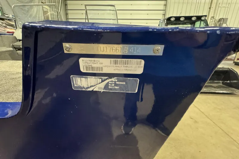 Slide: The Image of 2014 Tracker Pro Guide V-175 WT boat identification plate in a garage setting. - 7
