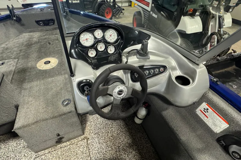 Slide: The Image of 2014 Tracker Pro Guide V-175 WT boat dashboard with steering wheel and gauges. - 9