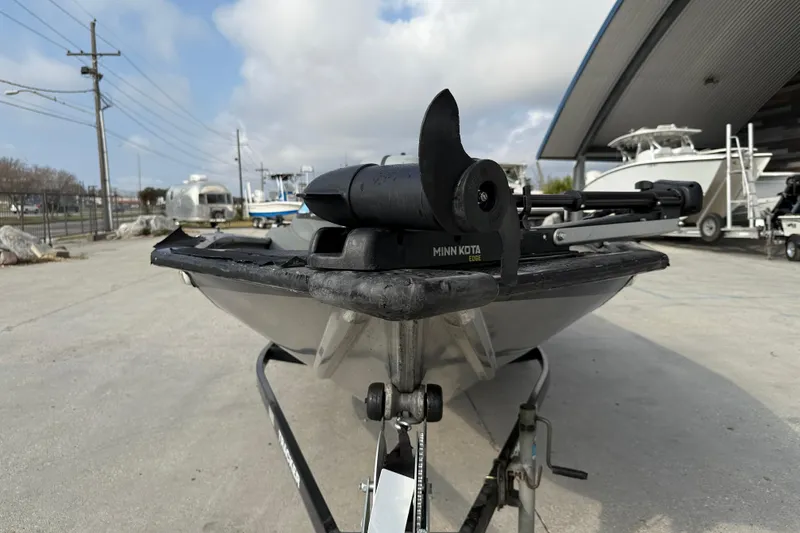 Slide: The Image of 2011 Bass Tracker PRO TEAM 190 TX with Minn Kota motor, parked outdoors. - 2