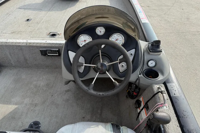 Slide: The Image of 2011 Bass Tracker PRO TEAM 190 TX boat dashboard with steering wheel and gauges. - 11