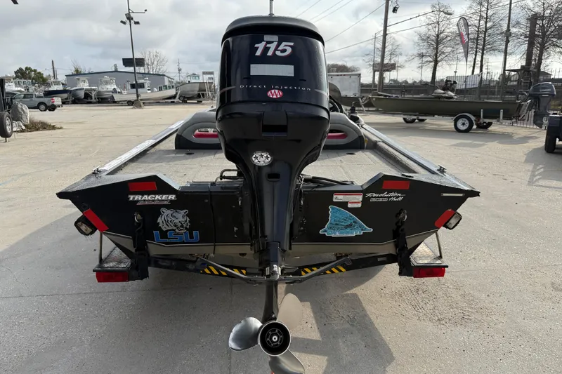 Slide: The Image of 2011 Bass Tracker PRO TEAM 190 TX boat with 115 HP engine, parked outdoors. - 5