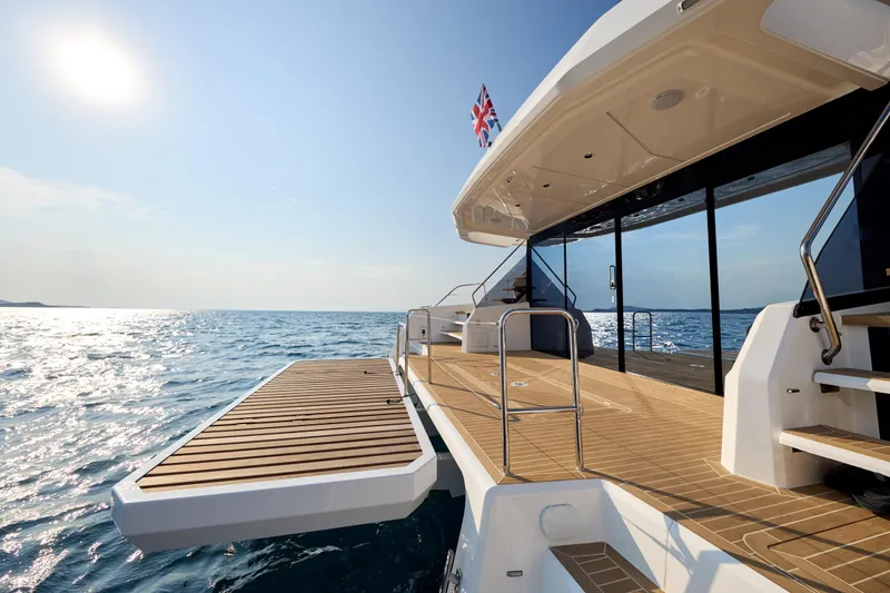 Slide: The Image of 2025 Custom Omaya 50 Power Catamaran on open sea, featuring spacious deck and modern design. - 29