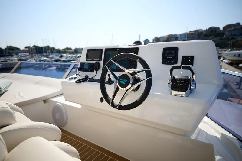 Slide: The Image of Helm of 2025 Custom Omaya 50 Power Catamaran with modern controls and marina view. - 48