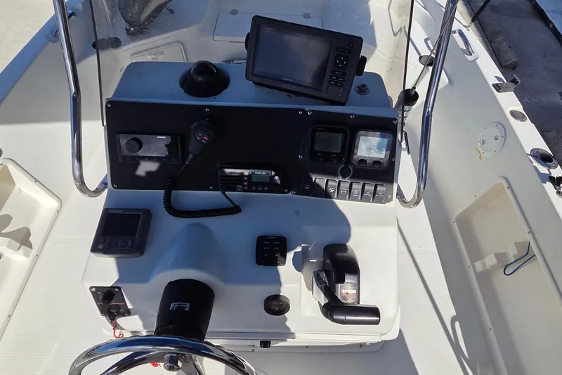 Slide: The Image of Control panel of a 2005 Sailfish 1900 BB Bay Boat with navigation equipment. - 13