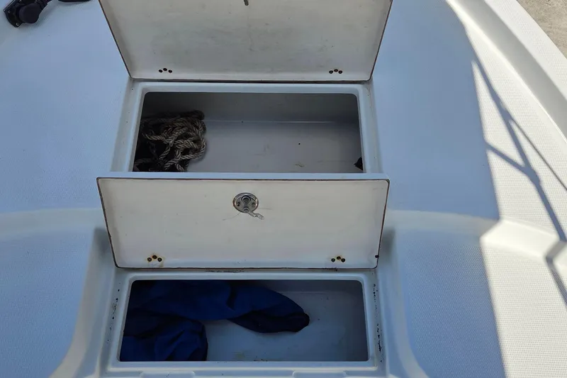 Slide: The Image of Open storage compartments on a 2005 Sailfish 1900 BB Bay Boat deck. - 5