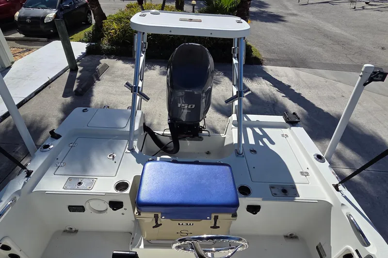 Slide: The Image of 2005 Sailfish 1900 BB Bay Boat with Yamaha 150 engine, docked on concrete. - 9