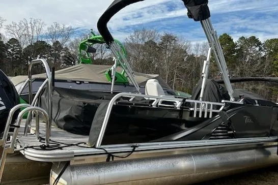 The Image of 2022 Tahoe Pontoon LTZ VRB/VRL boat with canopy, docked outdoors. - 1