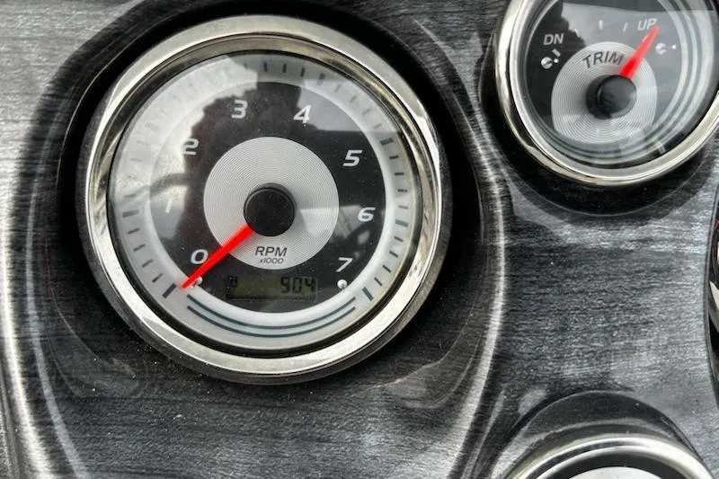 Slide: The Image of Close-up of 2022 Tahoe Pontoon LTZ VRB/VRL dashboard gauges, showing RPM and trim indicators. - 7
