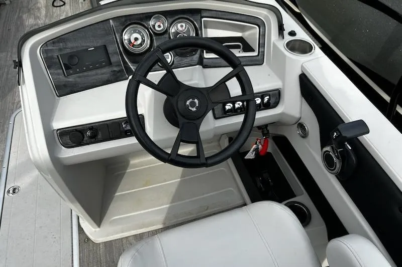 Slide: The Image of 2022 Tahoe Pontoon LTZ VRB/VRL steering console with gauges and controls. - 8