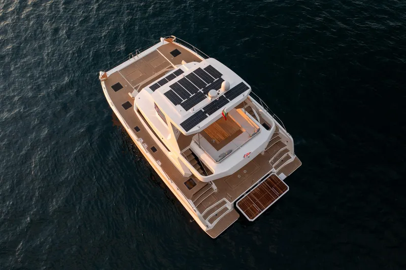 Slide: The Image of Aerial view of 2025 Custom Omaya 50 Power Catamaran with solar panels on deck. - 0