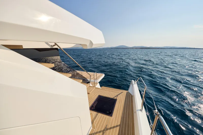 Slide: The Image of 2025 Custom Omaya 50 Power Catamaran on open sea, showcasing sleek deck design. - 28