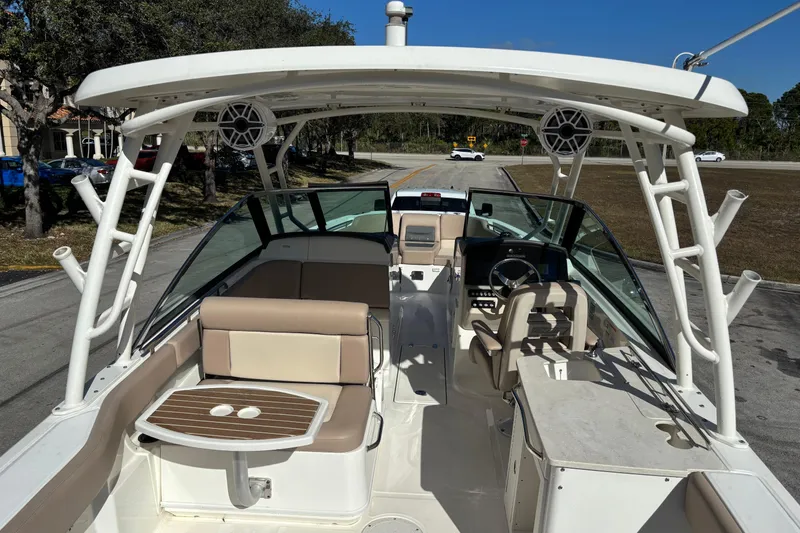 Slide: The Image of 2014 Boston Whaler 270 Vantage boat interior with seating and helm, parked on a sunny day. - 10
