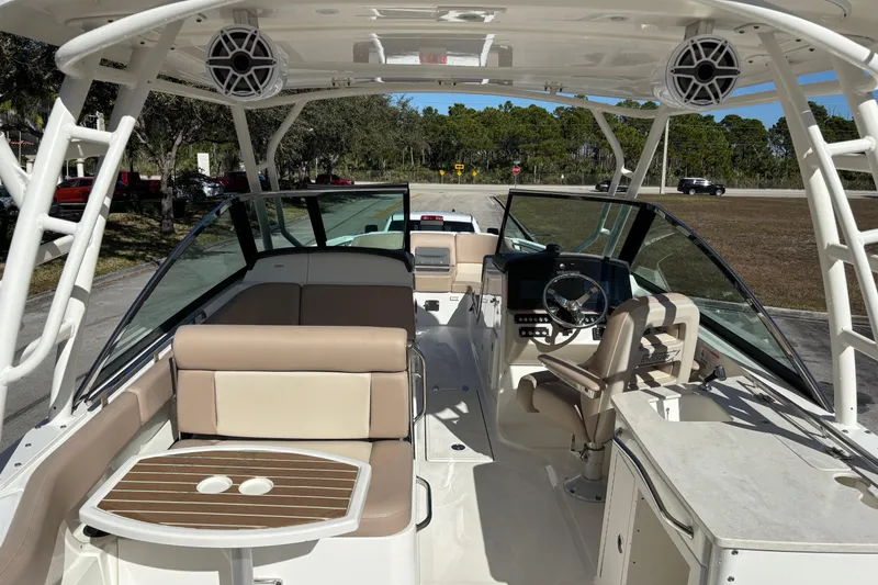 Slide: The Image of 2014 Boston Whaler 270 Vantage boat interior with seating and steering console. - 11