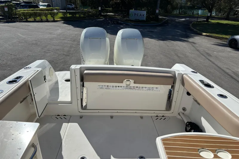 Slide: The Image of 2014 Boston Whaler 270 Vantage boat interior with dual engines and seating area. - 12