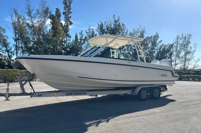 Slide: The Image of 2014 Boston Whaler 270 Vantage boat on trailer, parked outdoors. - 2