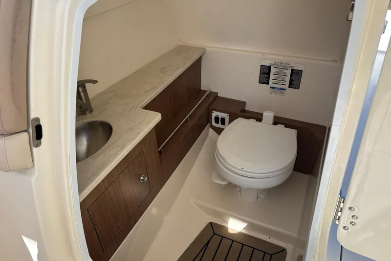 Slide: The Image of 2014 Boston Whaler 270 Vantage boat bathroom with sink and toilet. - 20