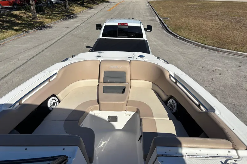 Slide: The Image of 2014 Boston Whaler 270 Vantage boat interior with beige seating, on trailer. - 21