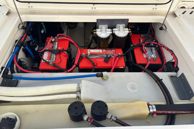 Slide: The Image of Engine compartment of a 2014 Boston Whaler 270 Vantage with batteries and wiring. - 27