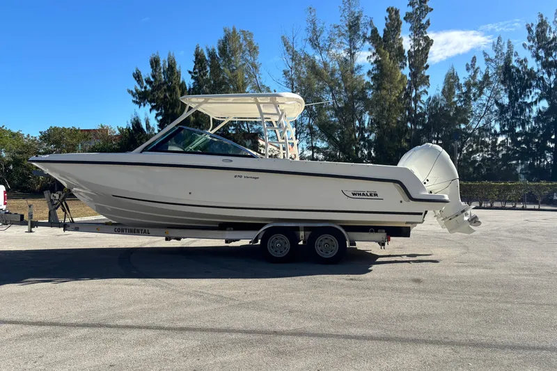 Slide: The Image of 2014 Boston Whaler 270 Vantage boat on trailer, parked outdoors. - 3