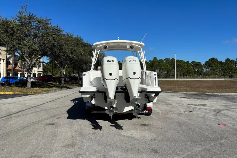 Slide: The Image of 2014 Boston Whaler 270 Vantage boat with dual 225 horsepower engines, parked outdoors. - 5