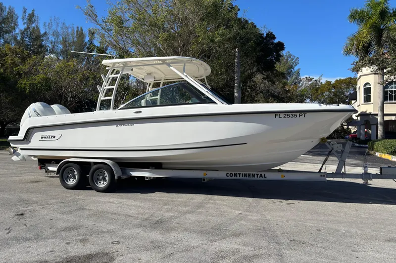 Slide: The Image of 2014 Boston Whaler 270 Vantage boat on trailer, parked outdoors. - 7