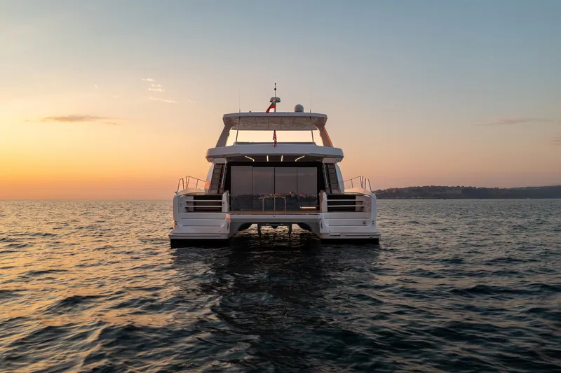 Slide: The Image of 2025 Custom Omaya 50 Power Catamaran at sunset on open water. - 7