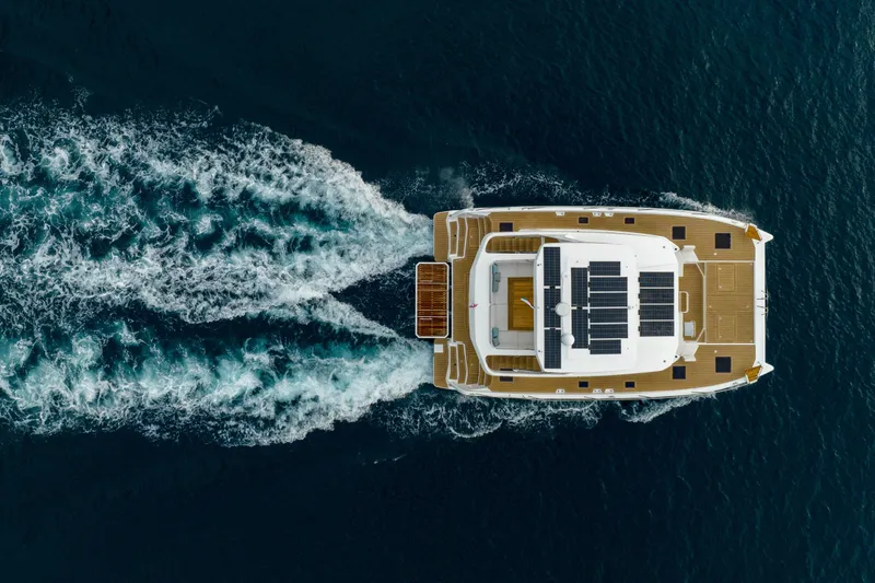 Slide: The Image of Aerial view of 2025 Custom Omaya 50 Power Catamaran cruising on the ocean. - 3