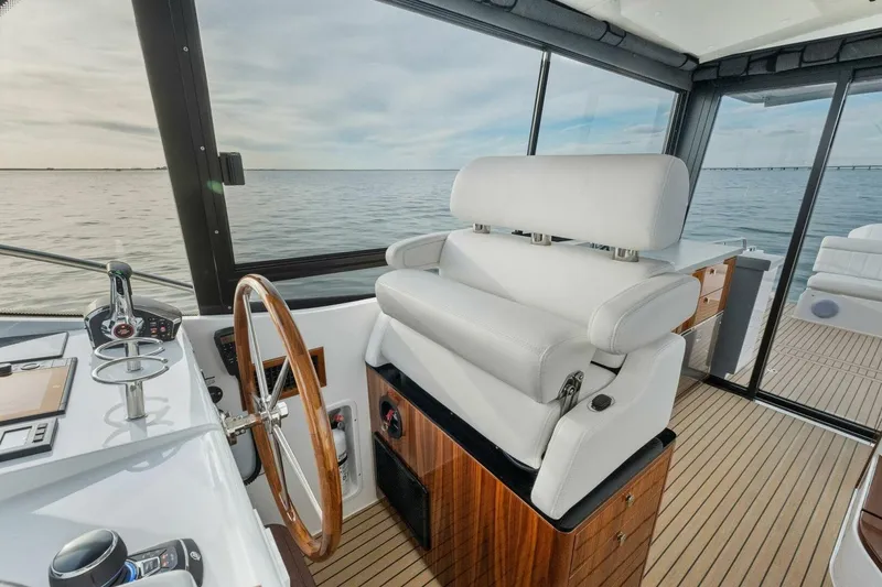 Slide: The Image of Helm of 2025 MJM 42 yacht with luxurious seating and ocean view. - 12