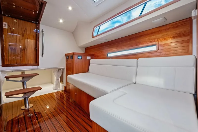 Slide: The Image of Luxurious interior of 2025 MJM 42 yacht with white seating and wooden accents. - 15