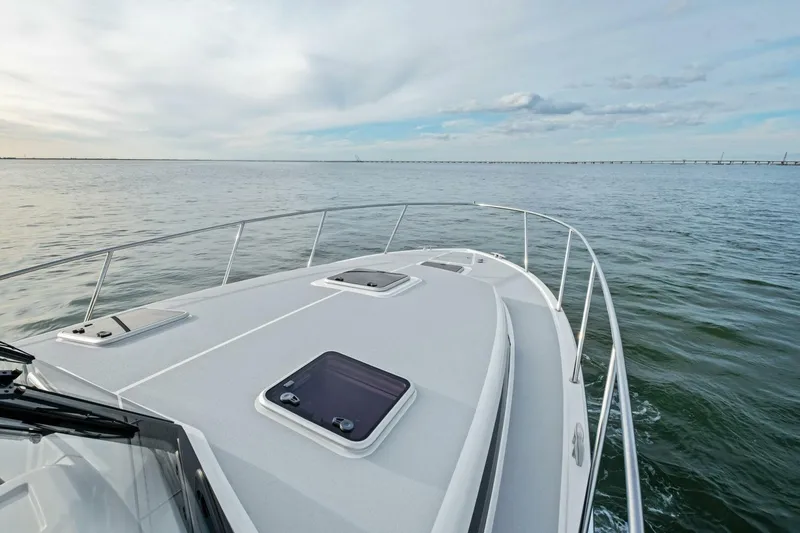 Slide: The Image of 2025 MJM 42 yacht cruising on open water under a cloudy sky. - 23