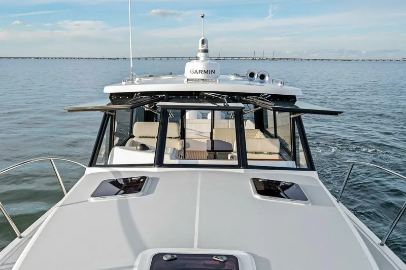 Slide: The Image of 2025 MJM 42 boat cruising on open water with Garmin navigation system. - 24