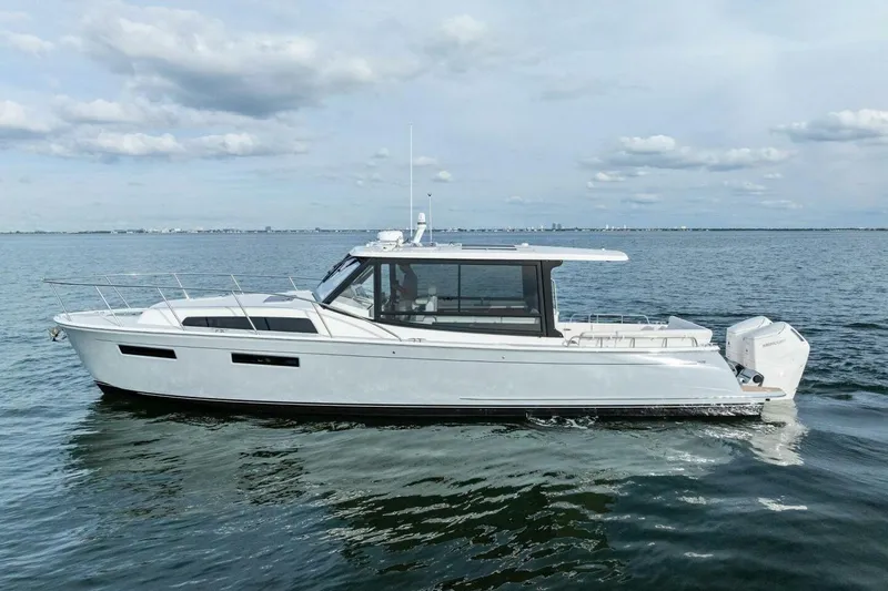 Slide: The Image of 2025 MJM 42 boat cruising on calm waters under a cloudy sky. - 35