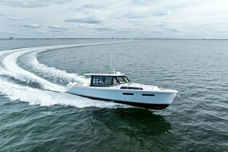 Slide: The Image of 2025 MJM 42 yacht cruising on open water, creating a dynamic wake. - 39