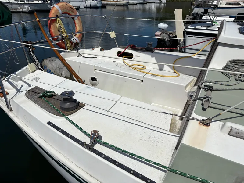 Slide: The Image of 1981 Newport 27 S sailboat deck with ropes and life preserver in marina. - 14