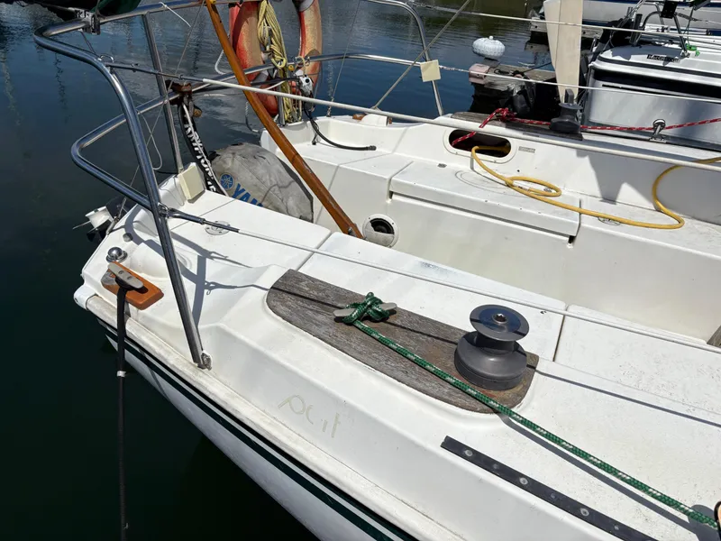 Slide: The Image of 1981 Newport 27 S sailboat deck with winch and safety equipment. - 16