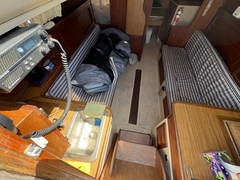 Slide: The Image of Interior of 1981 Newport 27 S sailboat with striped seating and radio equipment. - 27