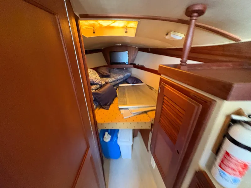 Slide: The Image of Cozy cabin interior of 1981 Newport 27 S sailboat with bed and storage. - 33