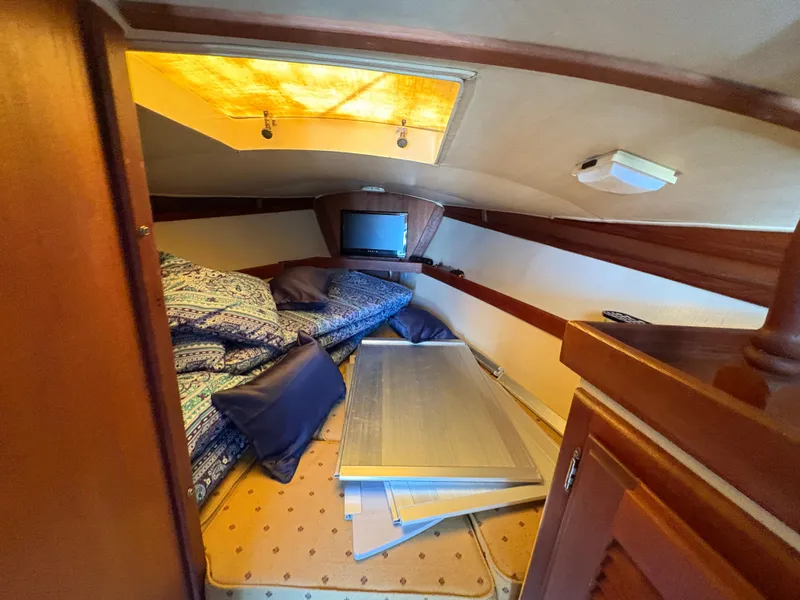 Slide: The Image of Cozy cabin interior of 1981 Newport 27 S sailboat with bedding and small TV. - 34