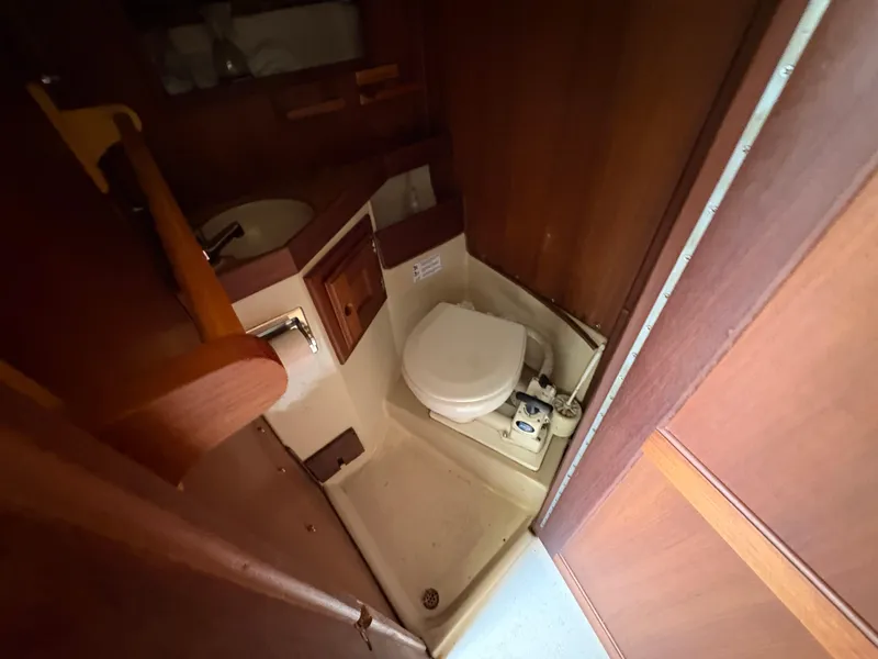 Slide: The Image of Compact bathroom in 1981 Newport 27 S sailboat with toilet and sink. - 37