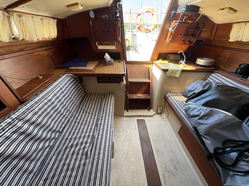 Slide: The Image of Interior of 1981 Newport 27 S sailboat with striped seating and wooden cabinetry. - 41