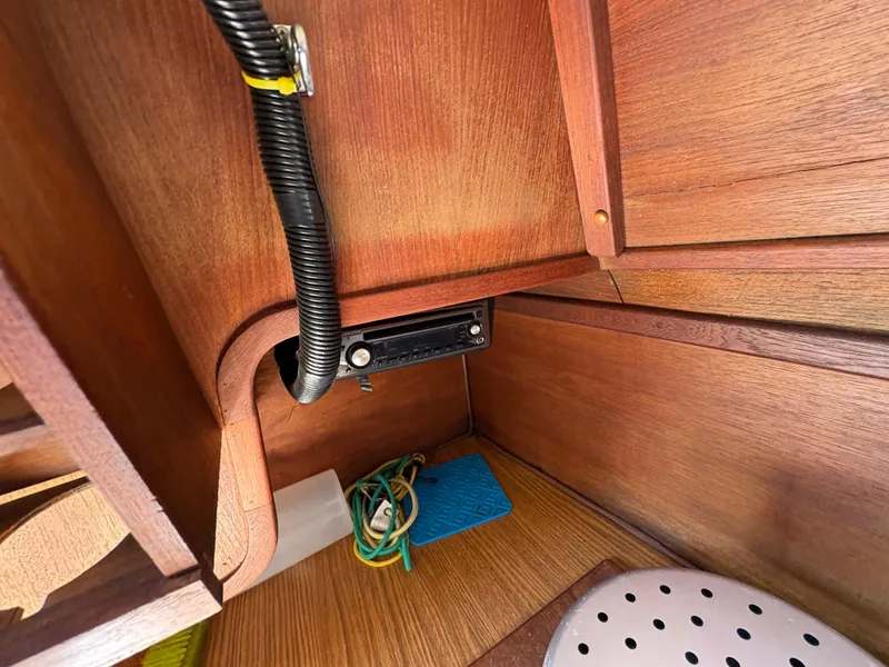 Slide: The Image of Interior of 1981 Newport 27 S sailboat showing wooden cabinetry and wiring. - 48