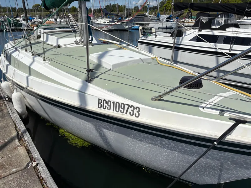 Slide: The Image of 1981 Newport 27 S sailboat docked at marina, registration number BC9109733 visible. - 7