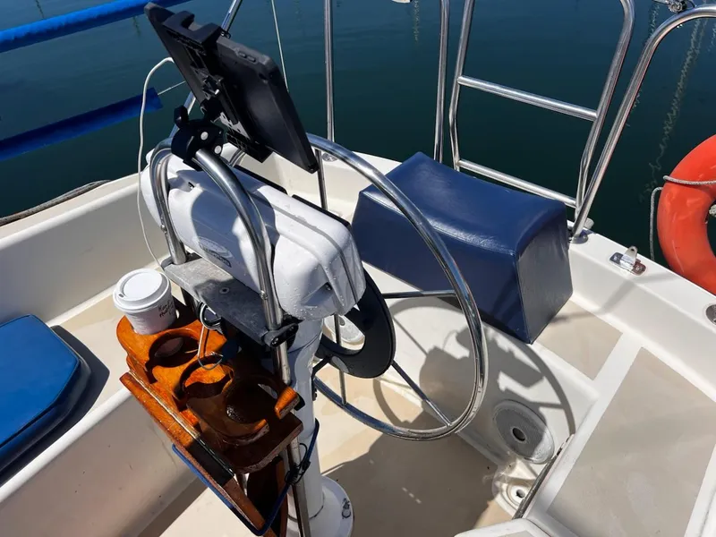 Slide: The Image of Cockpit of 1982 O'Day 28 sailboat with steering wheel, tablet holder, and cup holder. - 10