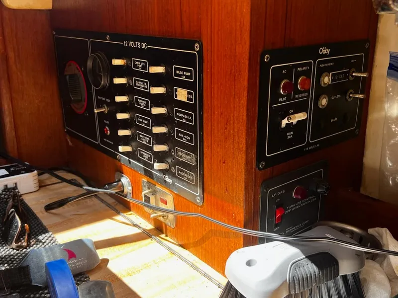 Slide: The Image of Electrical control panel inside a 1982 O'Day 28 sailboat, featuring switches and wiring. - 13