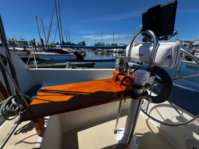 Slide: The Image of Cockpit of 1982 O'Day 28 sailboat with wooden table and steering wheel in marina. - 15